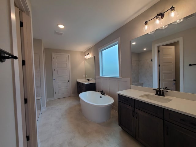 bathroom featuring vanity and separate shower and tub