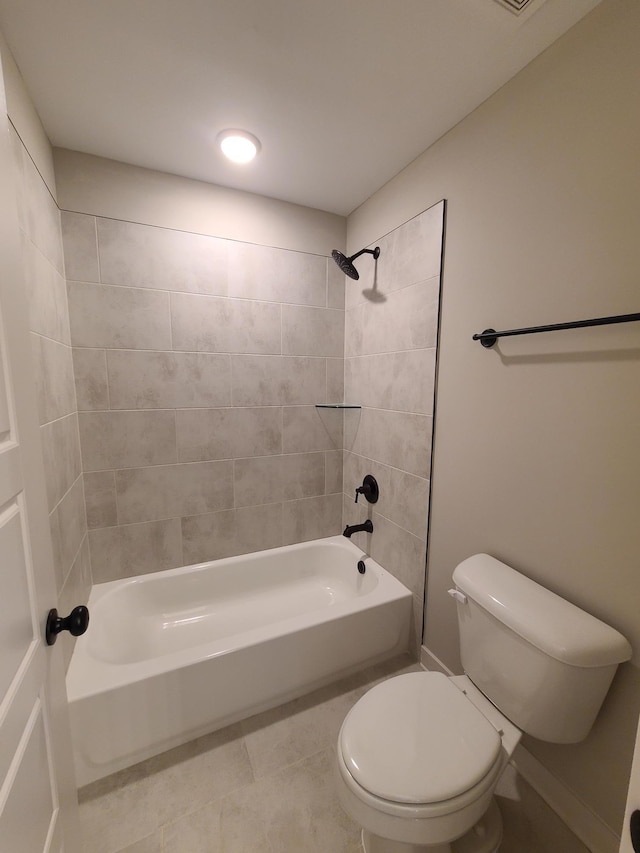 bathroom with tiled shower / bath combo and toilet