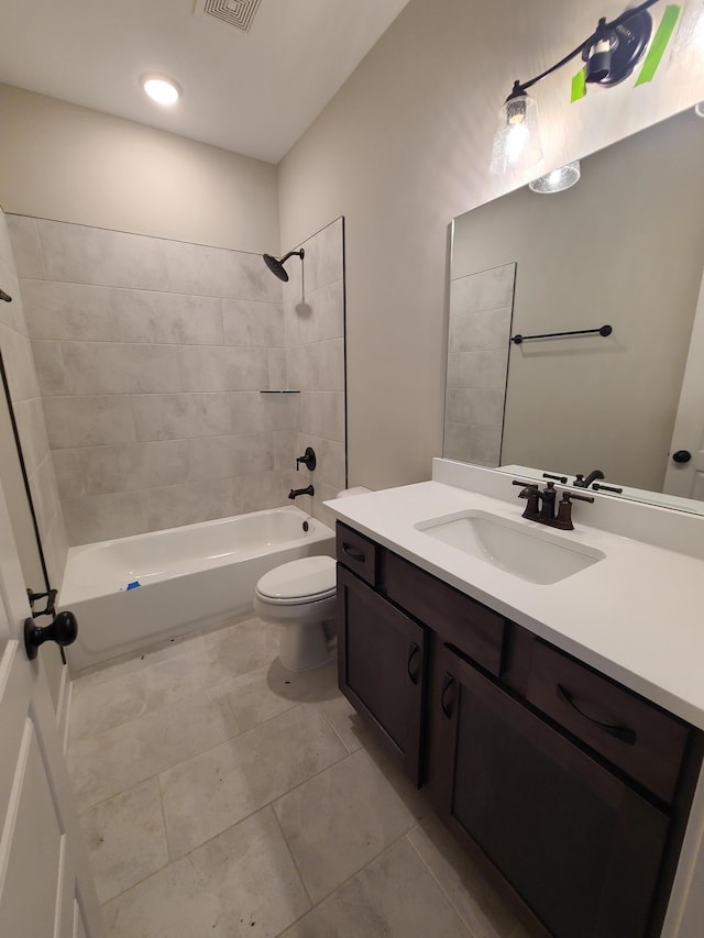 full bathroom with tiled shower / bath combo, vanity, tile patterned flooring, and toilet