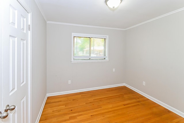 spare room featuring crown molding and wood-type flooring