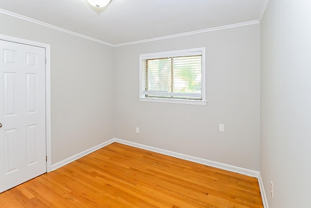 spare room featuring ornamental molding and hardwood / wood-style floors