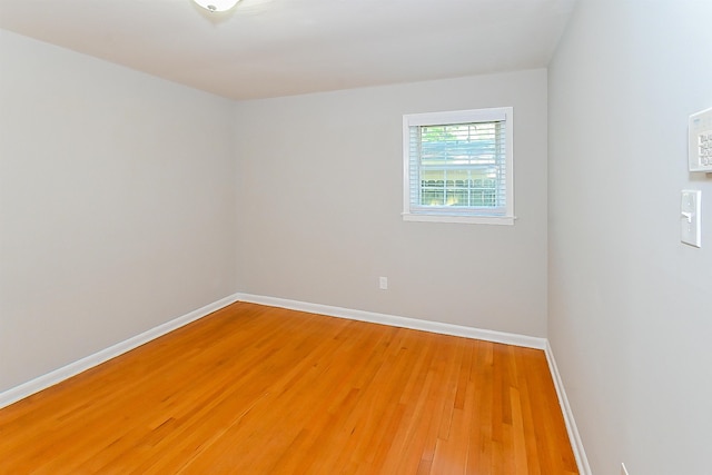 empty room with hardwood / wood-style floors