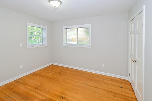 unfurnished room featuring hardwood / wood-style flooring