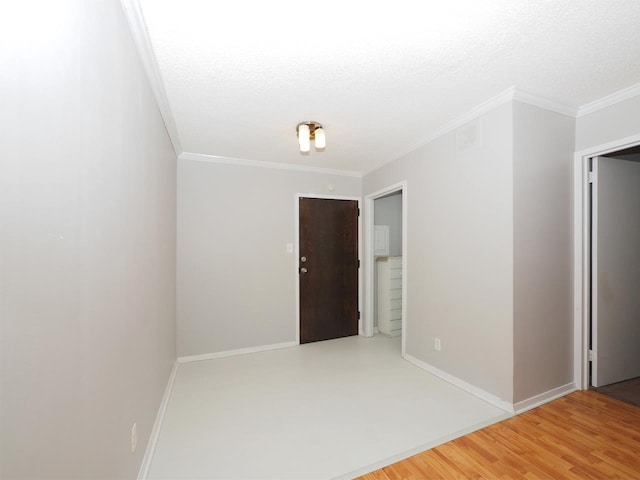 unfurnished room with hardwood / wood-style flooring, ornamental molding, and a textured ceiling