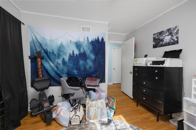 interior space featuring ornamental molding and light wood-type flooring