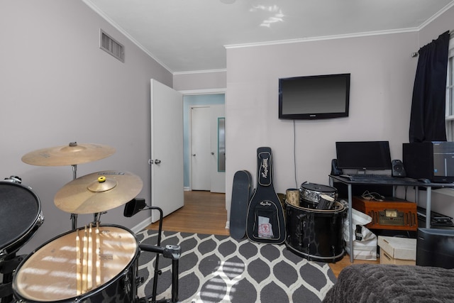 office area with ornamental molding and hardwood / wood-style floors