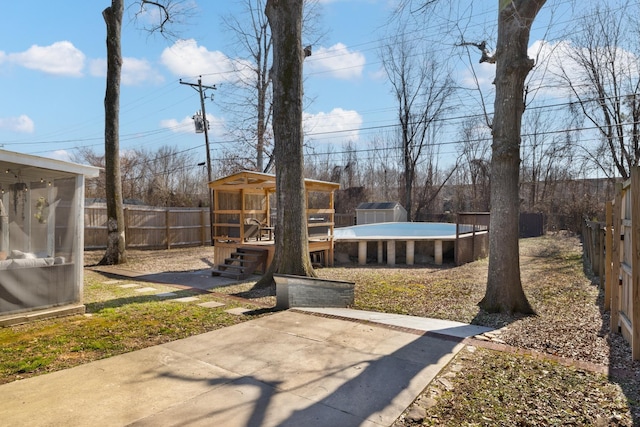 view of yard with a fenced in pool, an outbuilding, and a patio area