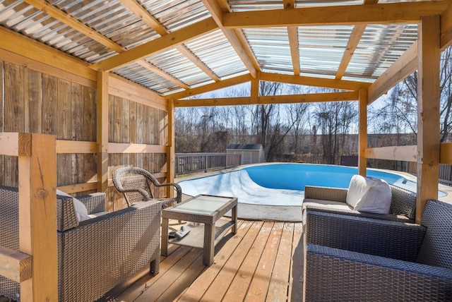 view of pool featuring a wooden deck and outdoor lounge area