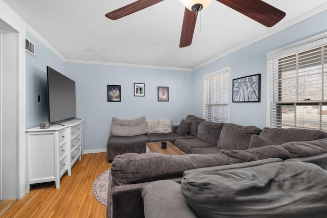 living room with crown molding, ceiling fan, and light hardwood / wood-style floors