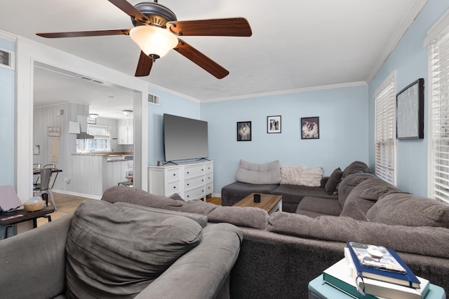 living room with crown molding and ceiling fan