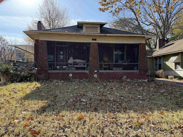 view of front of home featuring a sunroom