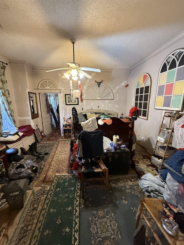 miscellaneous room featuring a textured ceiling, ornamental molding, and ceiling fan