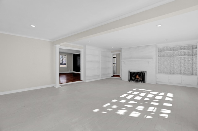 unfurnished living room with crown molding and a large fireplace