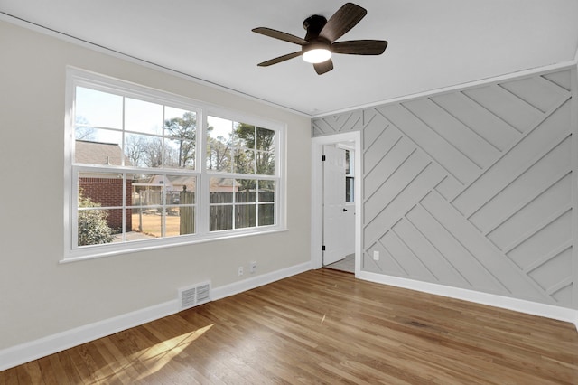 spare room with hardwood / wood-style flooring and ceiling fan