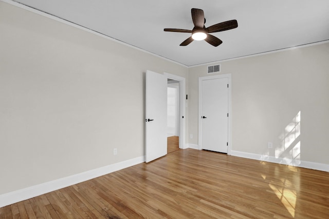 empty room with ceiling fan and light wood-type flooring