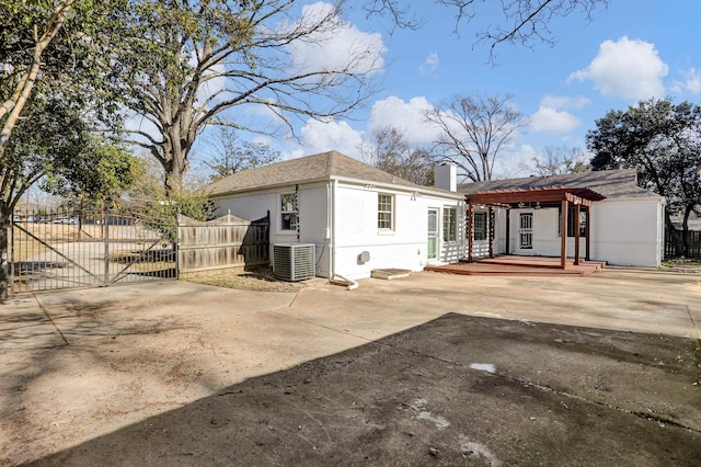 rear view of house with a pergola, central AC, and a patio