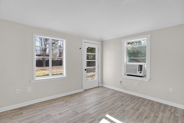 spare room with cooling unit and light hardwood / wood-style floors