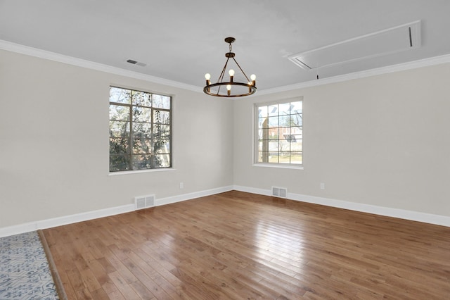 unfurnished room with crown molding, plenty of natural light, and wood-type flooring