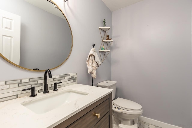 bathroom featuring tile patterned flooring, toilet, vanity, and decorative backsplash