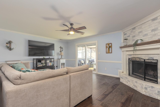 living room with a fireplace, ornamental molding, dark hardwood / wood-style floors, and ceiling fan