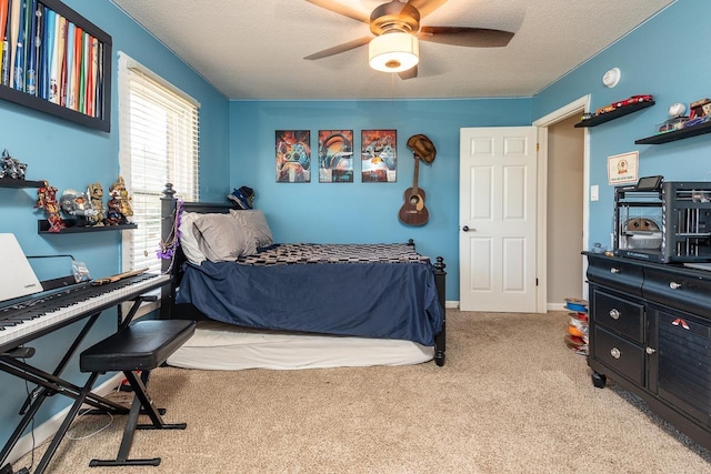 carpeted bedroom featuring ceiling fan and a textured ceiling