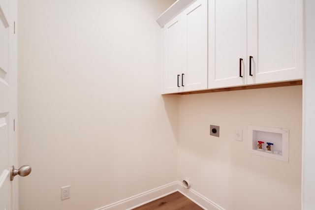 laundry area with hardwood / wood-style flooring, cabinets, washer hookup, and electric dryer hookup