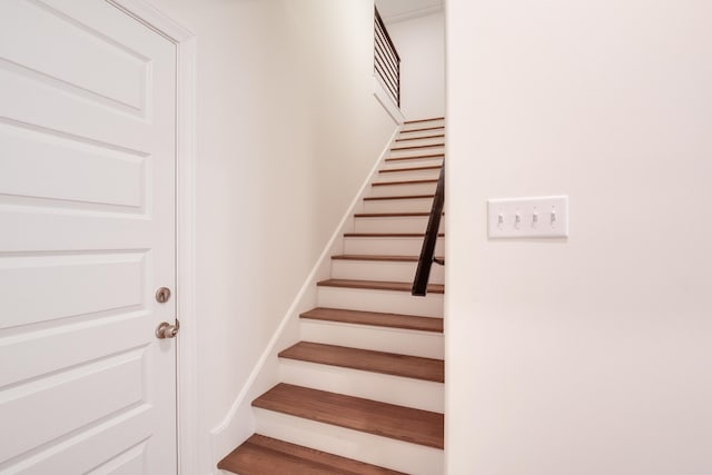 stairs with hardwood / wood-style flooring