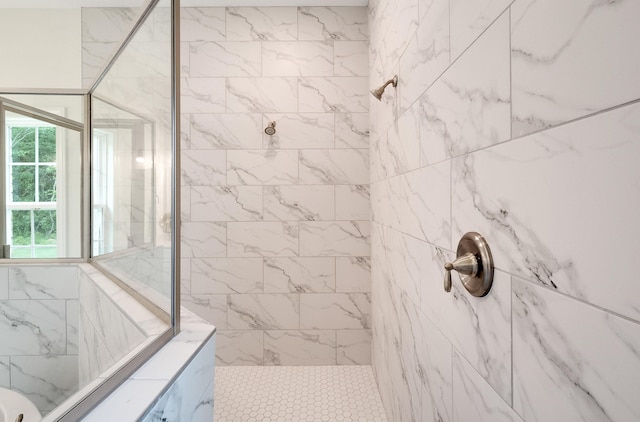 bathroom with a tile shower