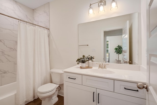 full bathroom featuring vanity, hardwood / wood-style floors, toilet, and shower / tub combo with curtain