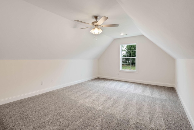 additional living space with carpet floors, ceiling fan, and vaulted ceiling