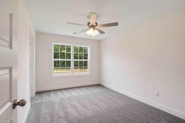 carpeted spare room featuring ceiling fan