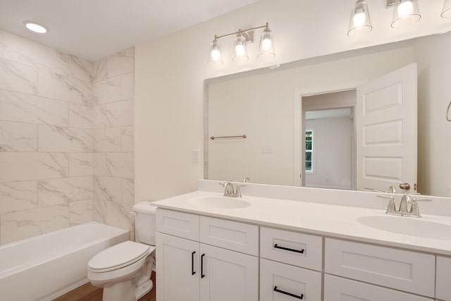 full bathroom with tiled shower / bath combo, vanity, and toilet