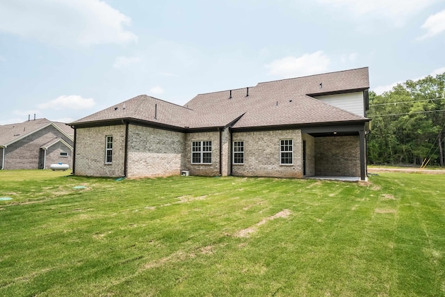 rear view of house featuring a lawn