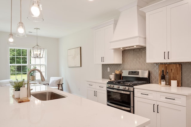 kitchen featuring sink, decorative backsplash, hanging light fixtures, double oven range, and custom range hood