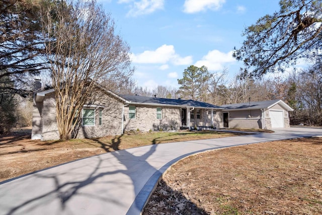 ranch-style home with a garage and a front yard