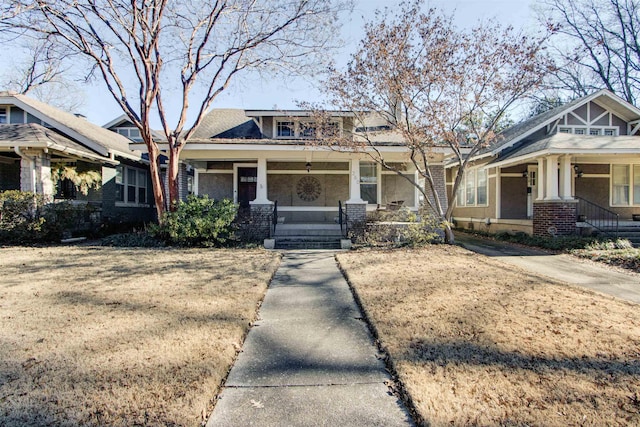 view of front of property with a porch and a front lawn