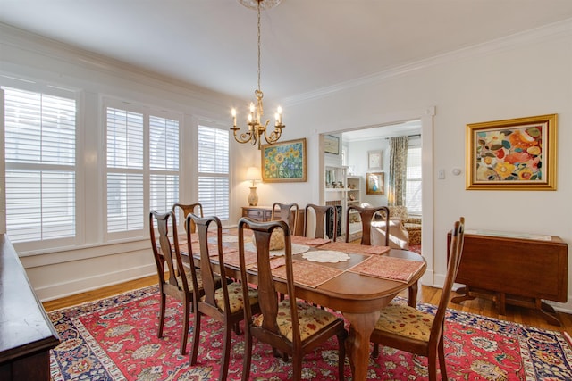 dining area featuring hardwood / wood-style floors, ornamental molding, and a wealth of natural light