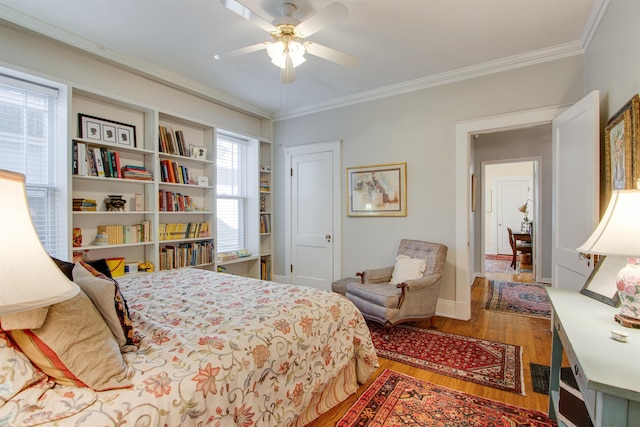 bedroom with hardwood / wood-style flooring, ceiling fan, and ornamental molding