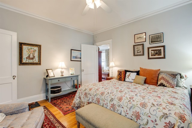 bedroom featuring crown molding, ceiling fan, and light hardwood / wood-style flooring