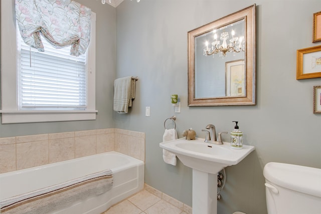 bathroom with tile patterned flooring, a washtub, and toilet