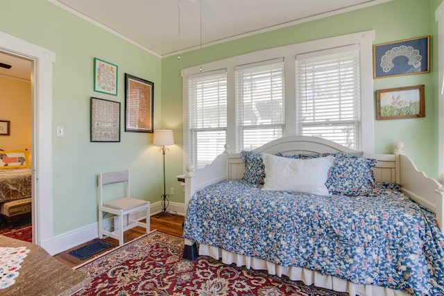 bedroom with hardwood / wood-style floors and crown molding