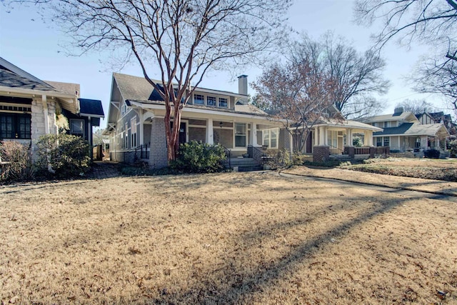 view of front of home featuring covered porch and a front lawn