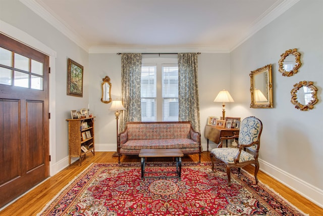 sitting room featuring hardwood / wood-style flooring and crown molding