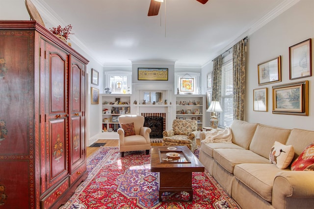 living room featuring a brick fireplace, ornamental molding, ceiling fan, and light wood-type flooring