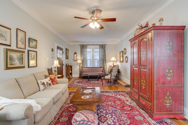 living room featuring crown molding, ceiling fan, and light hardwood / wood-style flooring