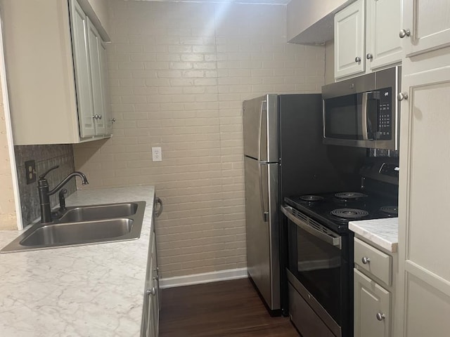 kitchen with sink, white cabinetry, black / electric stove, dark hardwood / wood-style flooring, and backsplash