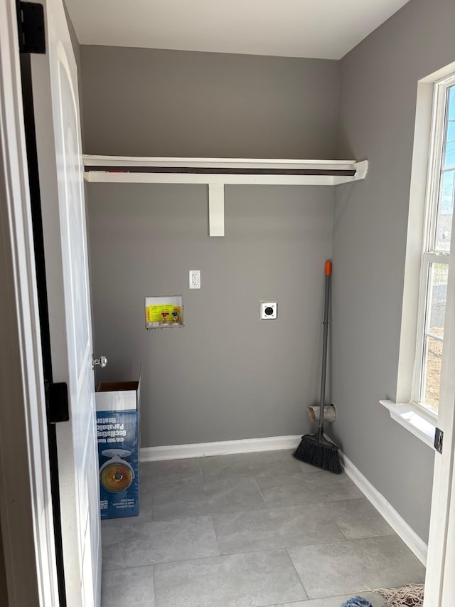 washroom with hookup for a washing machine, hookup for an electric dryer, and light tile patterned floors