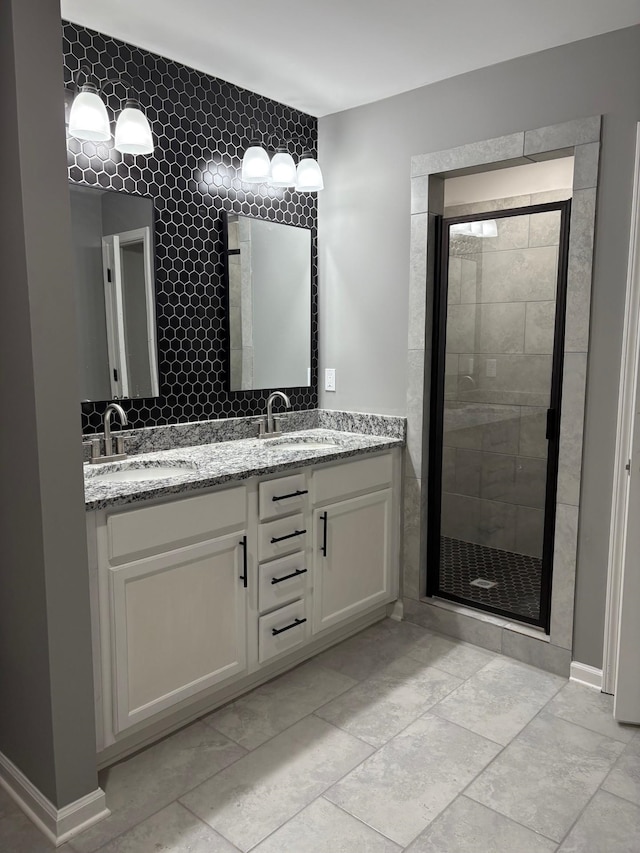 bathroom with vanity and a shower with door