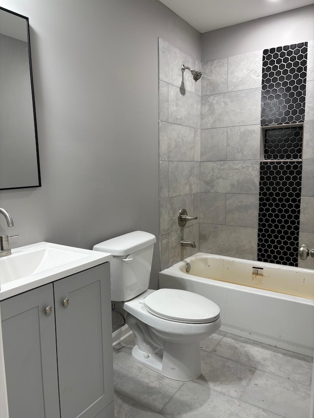 full bathroom featuring vanity, tiled shower / bath combo, and toilet