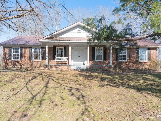 single story home featuring a front lawn and covered porch